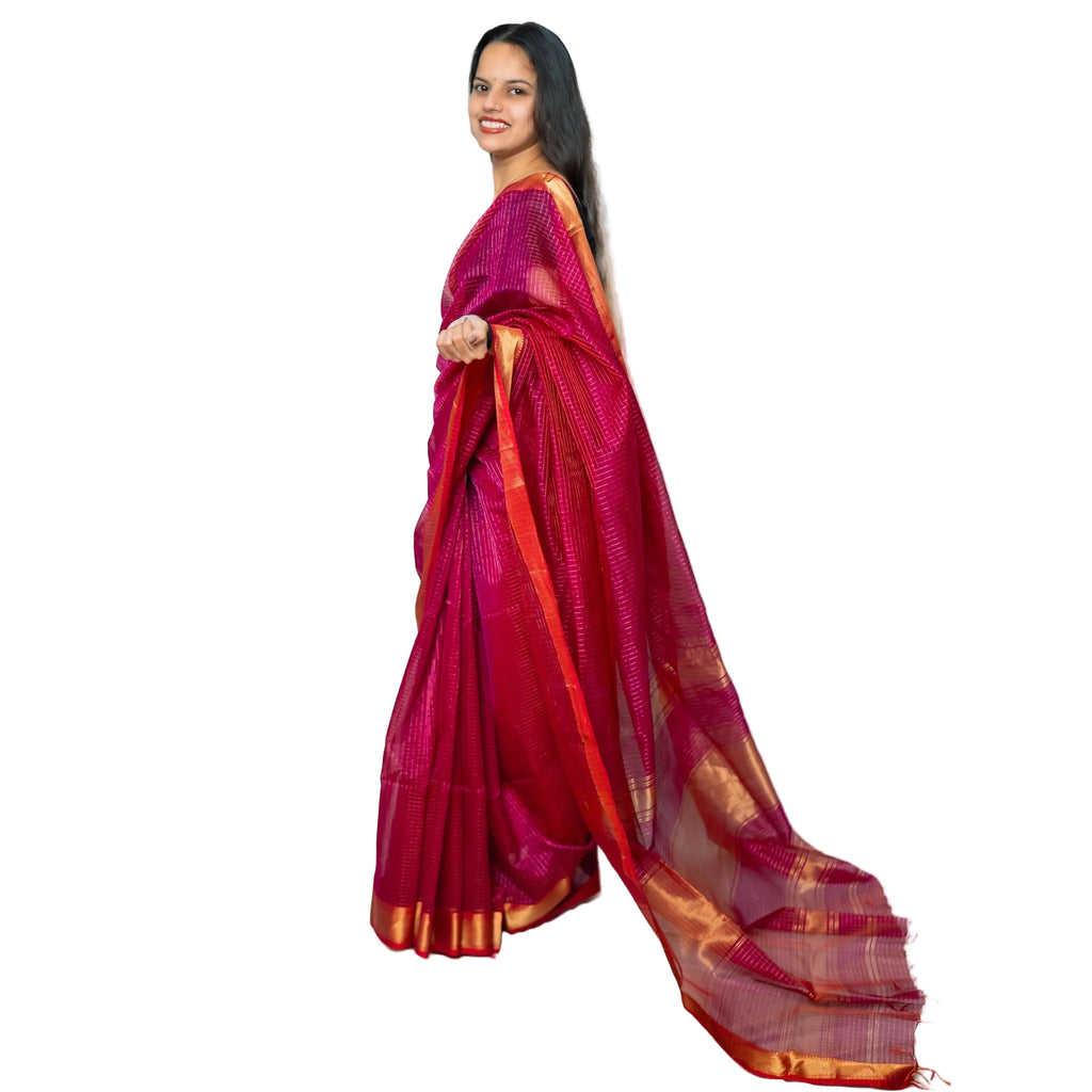 Woman wearing a red saree with gold border on a white background
